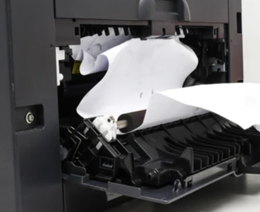 A black and white image of paper jammed in a printer.
